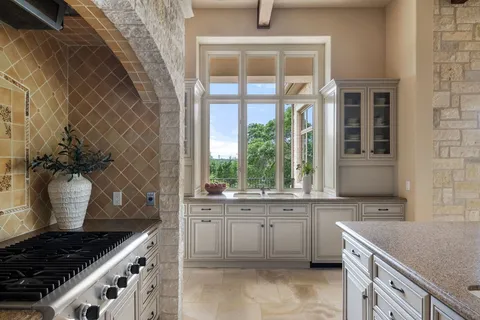 a kitchen with a sink stove and cabinets