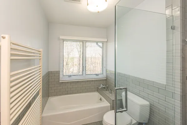 a bathroom with a bathtub and a shower