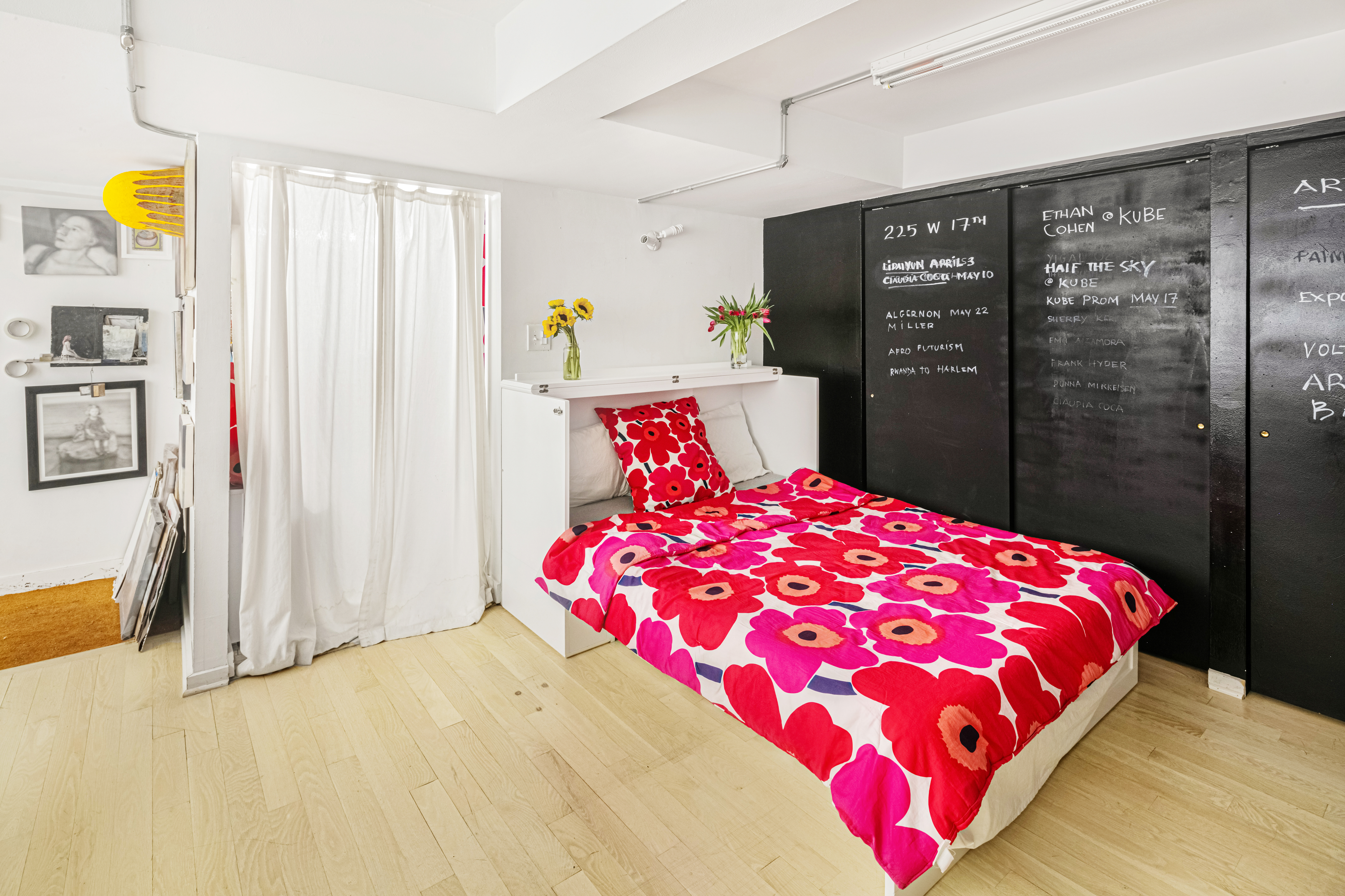 251 West 19th Street, Unit 1G Manhattan, NY 10011 - Photo 20 of 31 a bedroom with a large bed and a chandelier