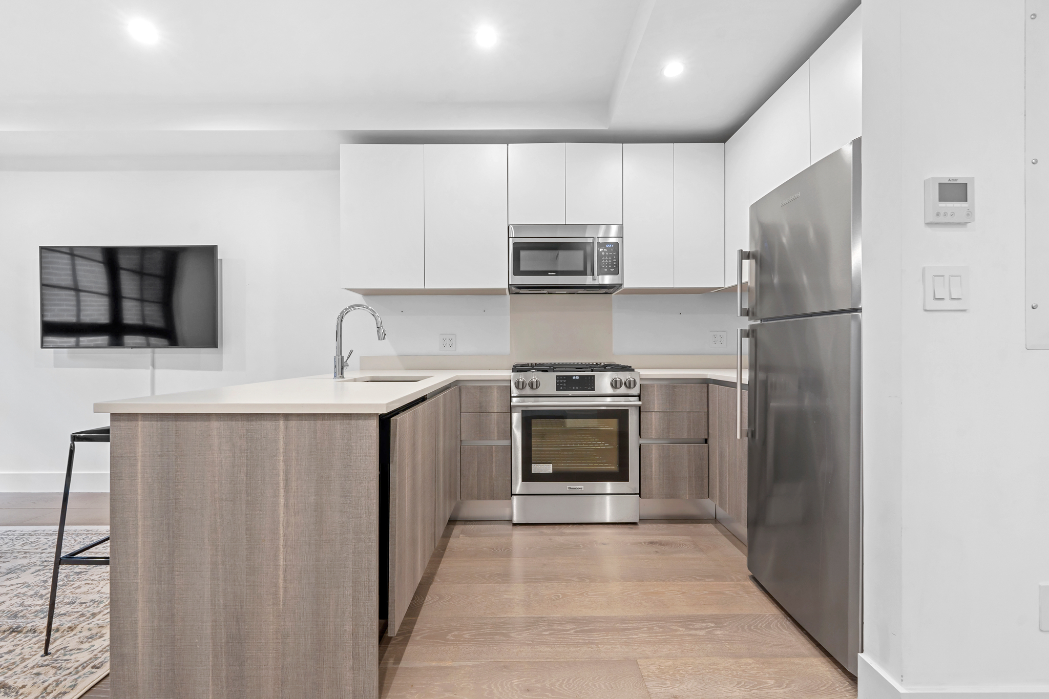 440 West 20th Street Manhattan, NY 10011 - Photo 24 of 35 a kitchen with stainless steel appliances a refrigerator stove and microwave
