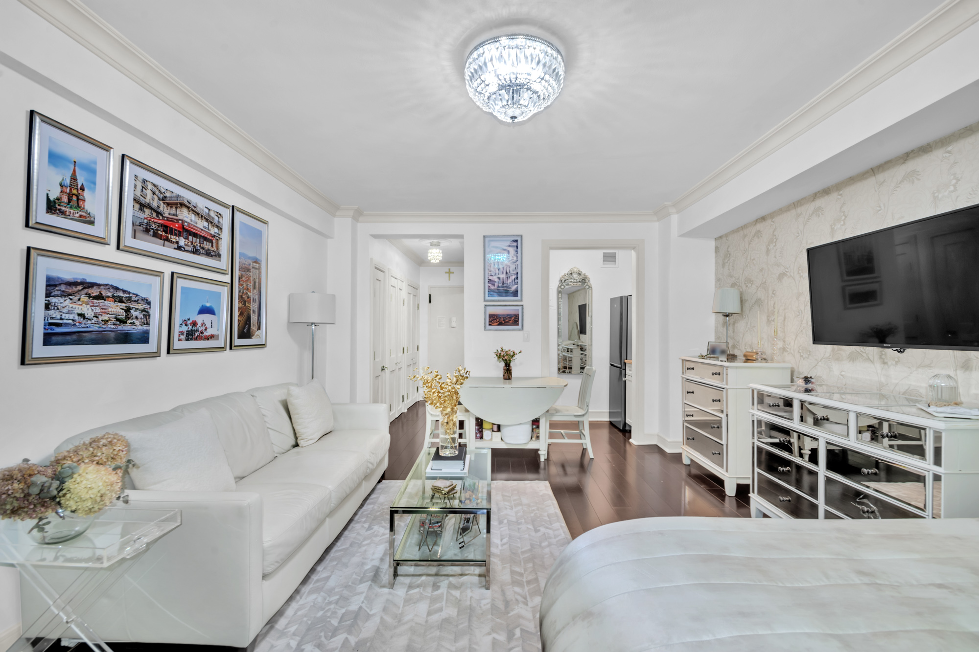 310 East 49th Street, Unit 1E Manhattan, NY 10017 - Photo 3 of 11 a living room with furniture and a flat screen tv