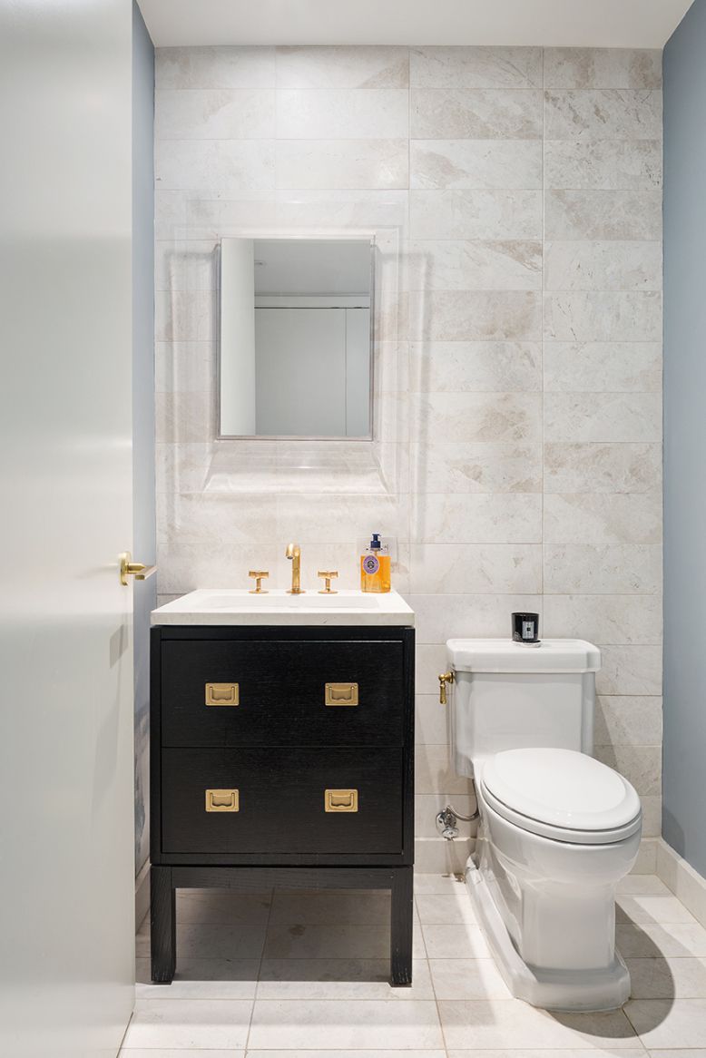 93 Worth Street, Unit 1401 Manhattan, NY 10013 - Photo 8 of 9 a bathroom with a granite countertop toilet sink and mirror