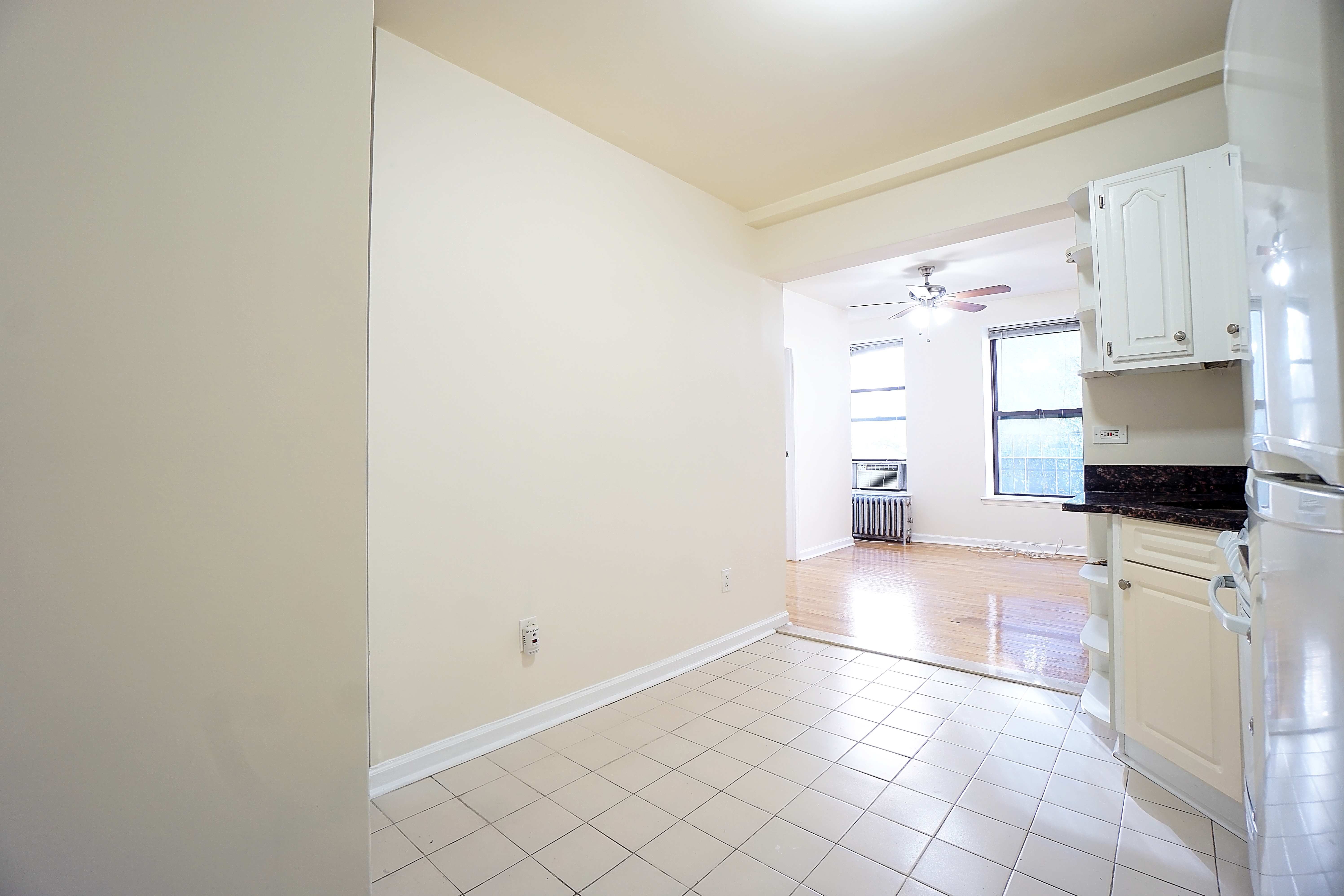 270 East 78th Street, Unit 10 Manhattan, NY 10075 - Photo 1 of 6 a view of a kitchen with white cabinets