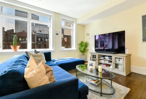 a living room with furniture fireplace and a flat screen tv