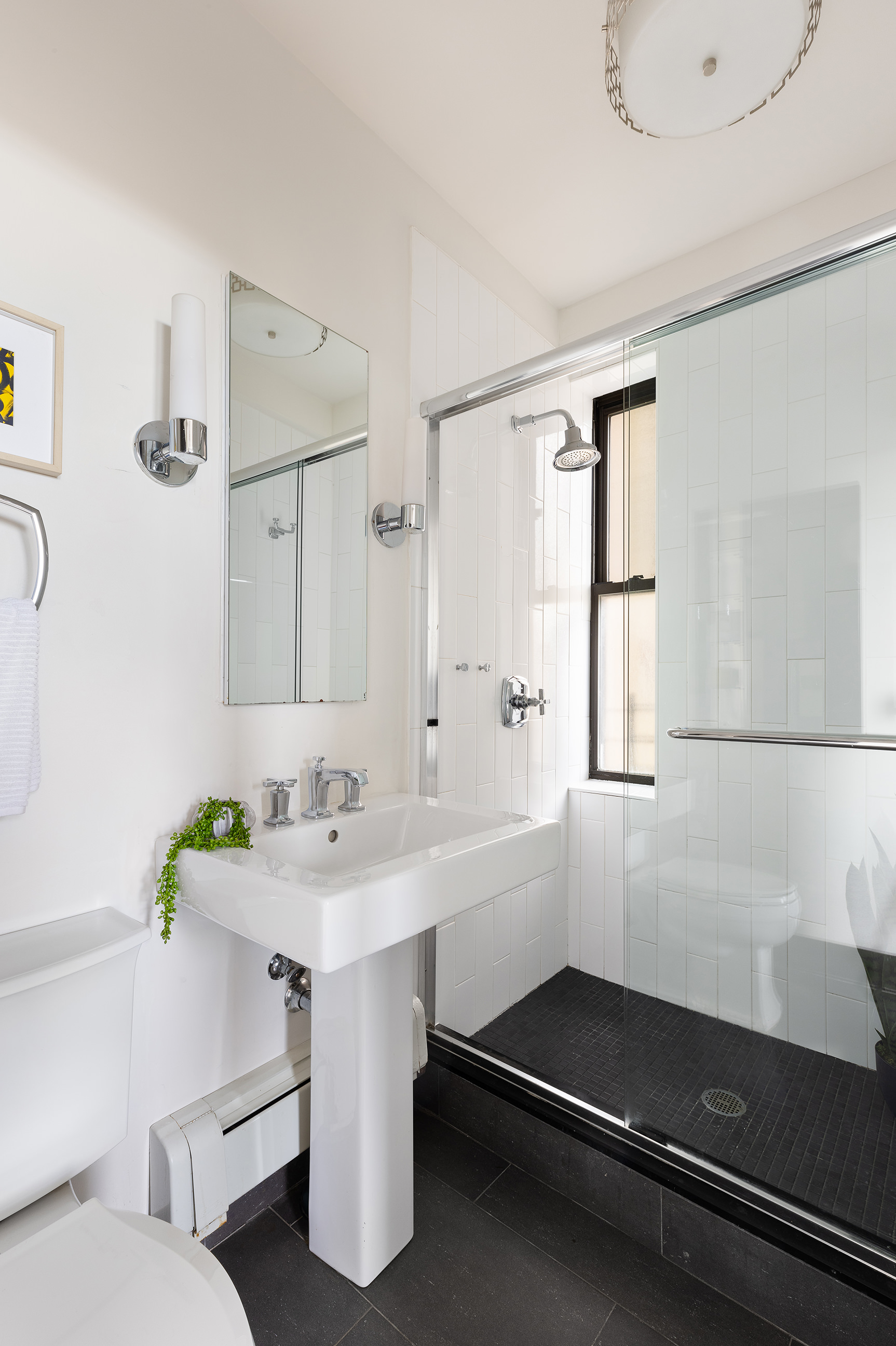 135 Eastern Parkway, Unit 7A Brooklyn, NY 11238 - Photo 12 of 15 a bathroom with a sink and a mirror