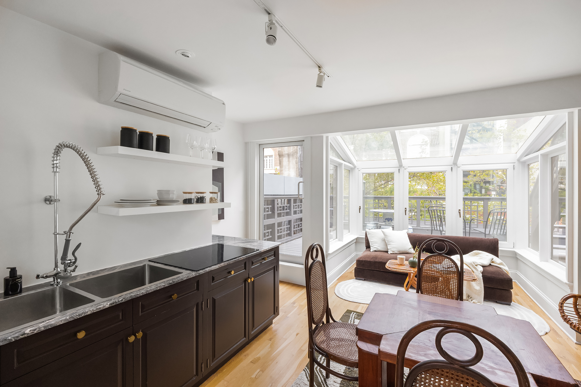 112 West 13th Street Manhattan, NY 10011 - Photo 38 of 46 a kitchen with granite countertop a table chairs stove and sink