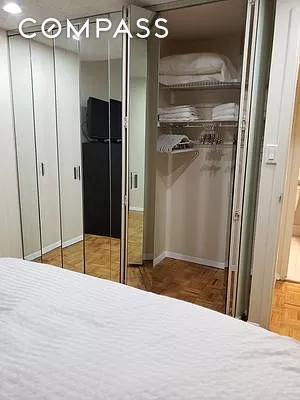 150 West 51st Street, Unit 1909 Manhattan, NY 10019 - Photo 8 of 12 a view of a hallway with wooden floor