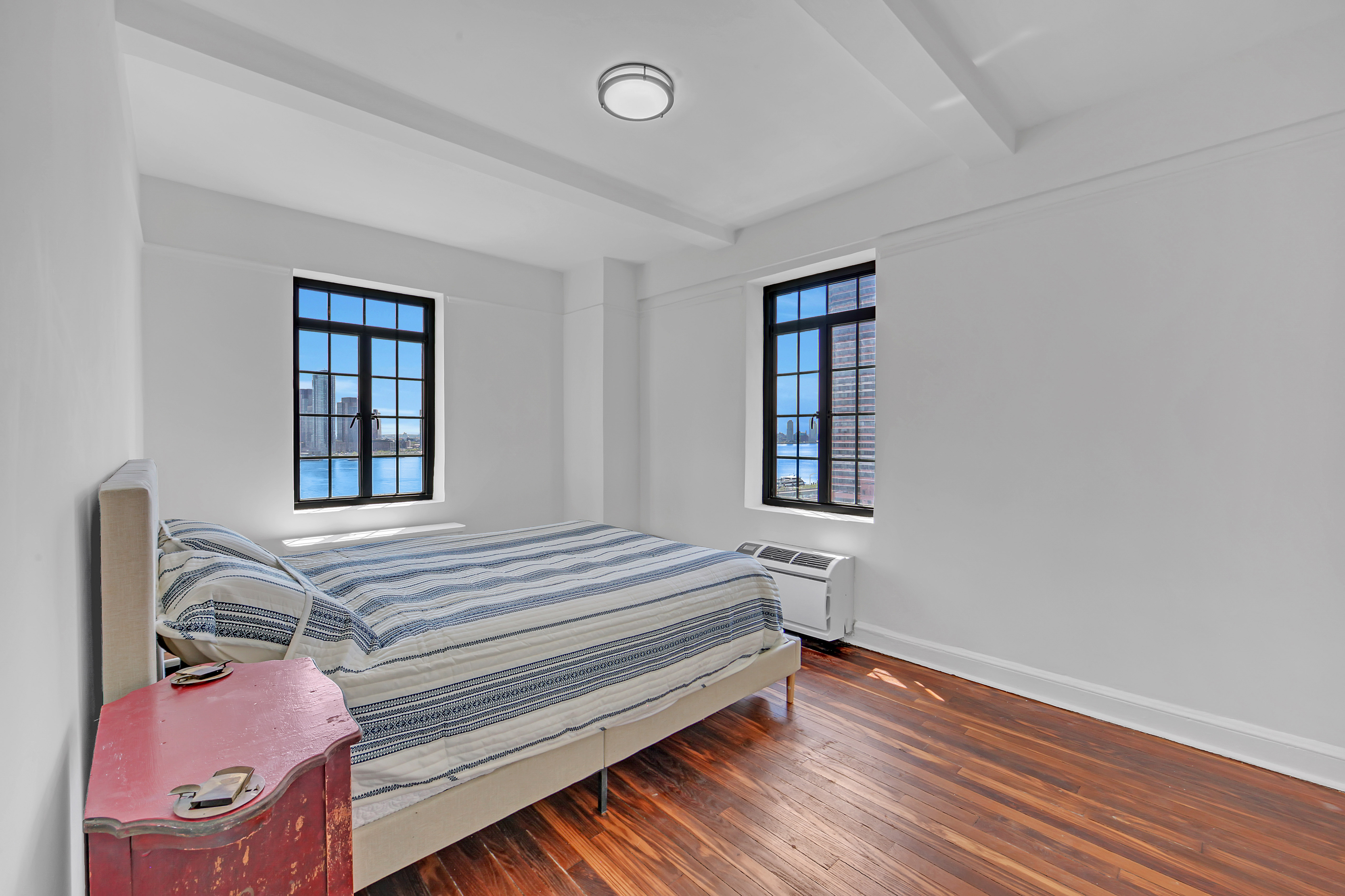 5 Tudor City Place, Unit 625 Manhattan, NY 10017 - Photo 6 of 11 a bedroom with a bed and a window
