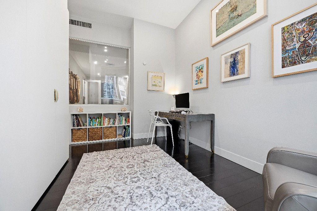 111 Fulton Street, Unit 824 Manhattan, NY 10038 - Photo 17 of 35 a living room with furniture and a flat screen tv
