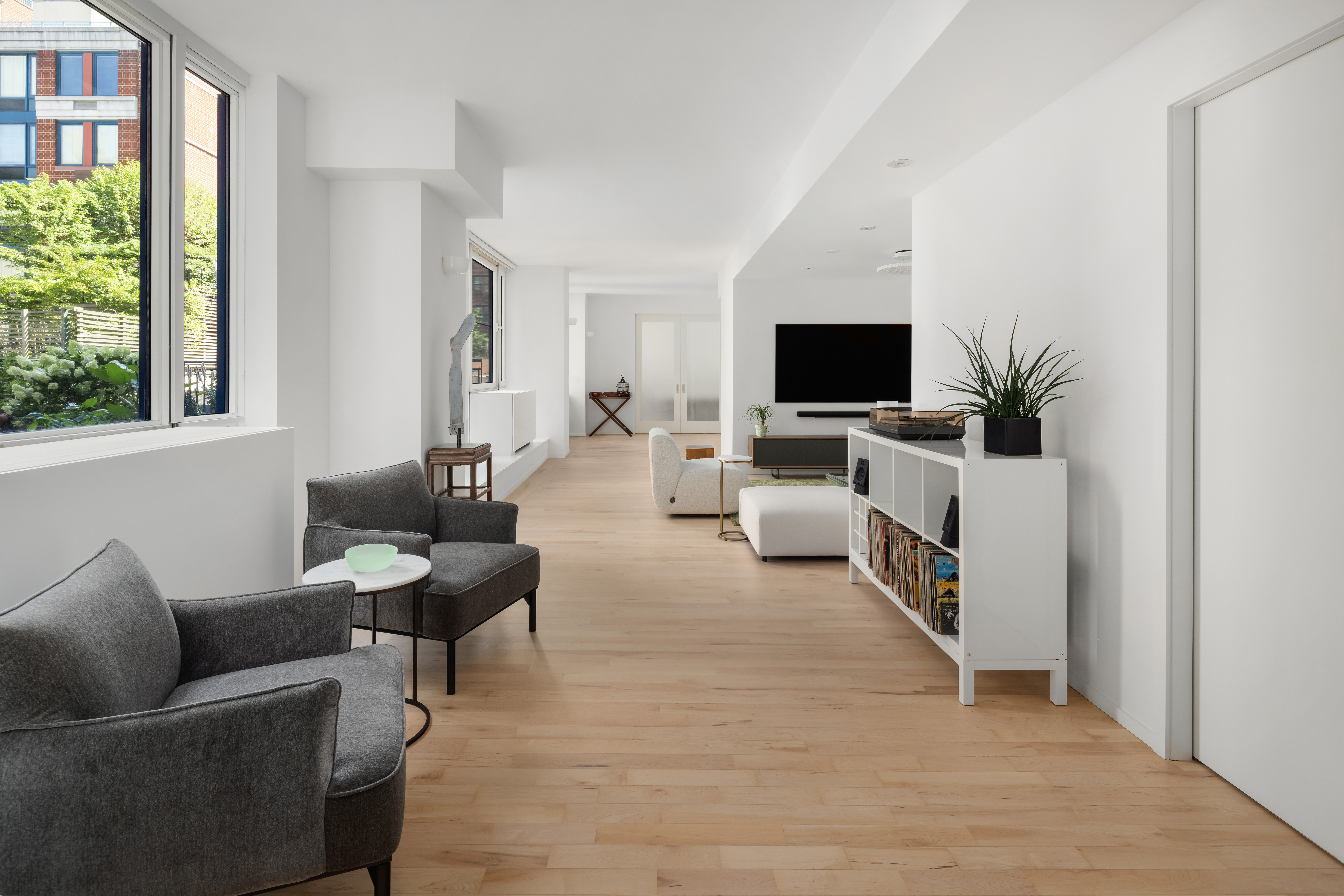 404 East 76th Street, Unit 2B Manhattan, NY 10021 - Photo 5 of 24 a living room with furniture and a flat screen tv