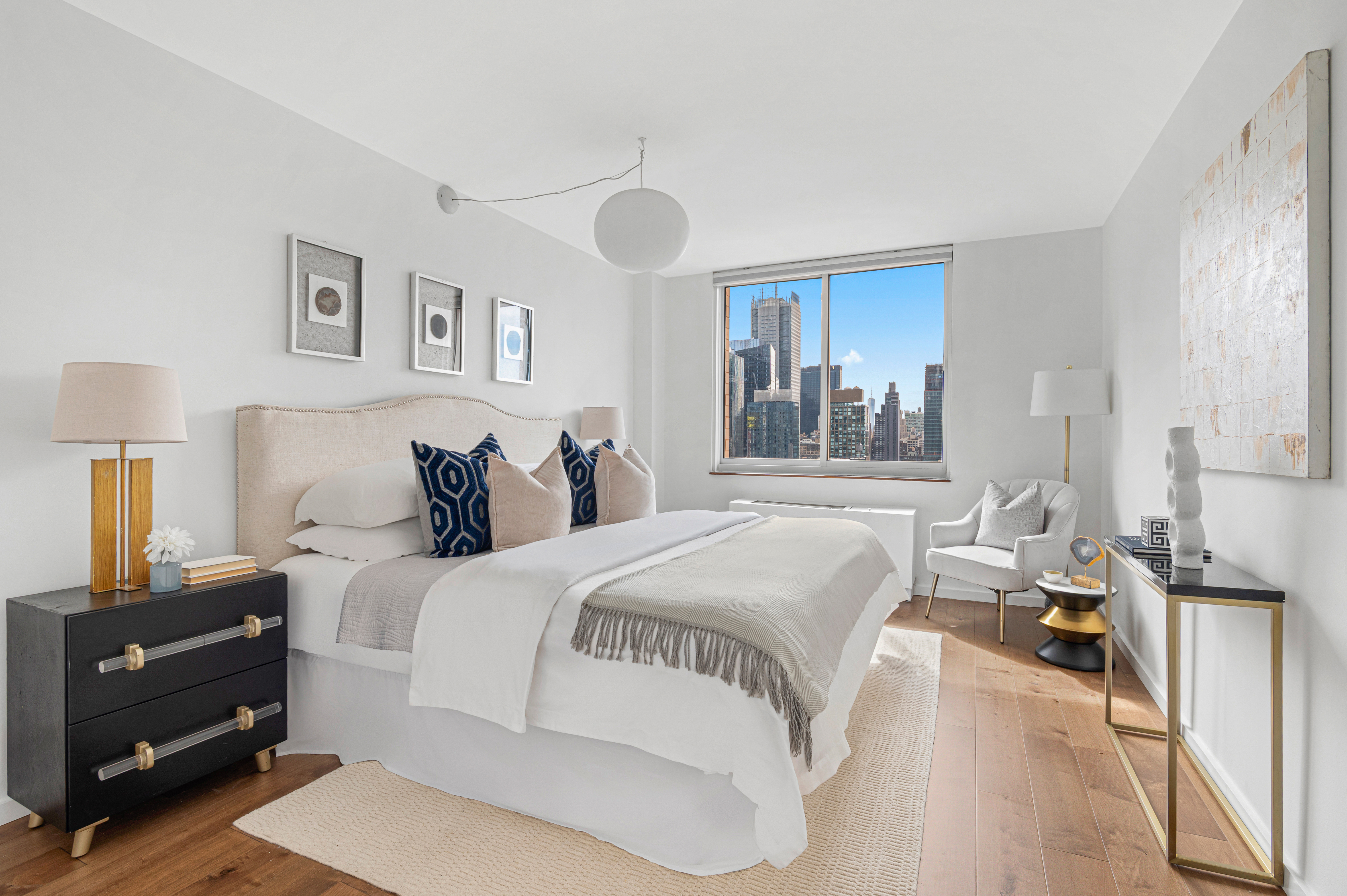 350 West 50th Street, Unit 29D Manhattan, NY 10019 - Photo 4 of 14 a bedroom with a bed and a cabinets