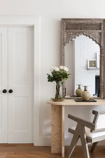 a dining room with table chairs and wooden floor
