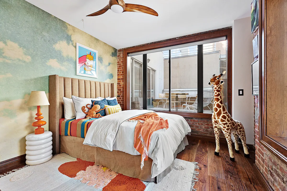 115 Allen Street, Unit 3 Manhattan, NY 10002 - Photo 10 of 13 a bed sitting in a bedroom next to a window