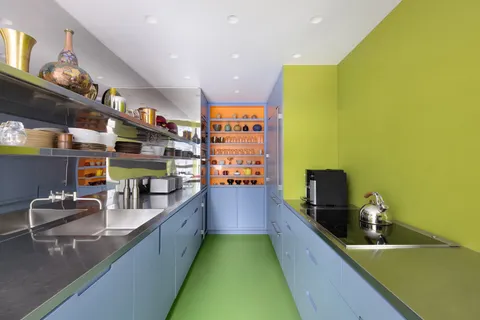 a kitchen with stainless steel appliances dining table and chairs