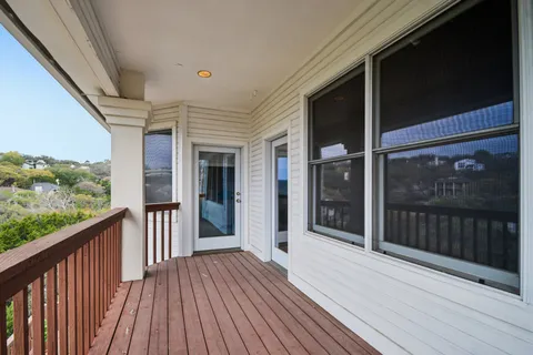 a view of a balcony with wooden floor