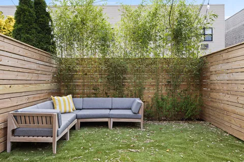 a view of a backyard with sitting area