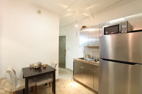 a kitchen with a refrigerator and a sink