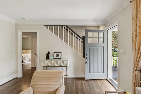 a view of a hallway with wooden floor fireplace and living room