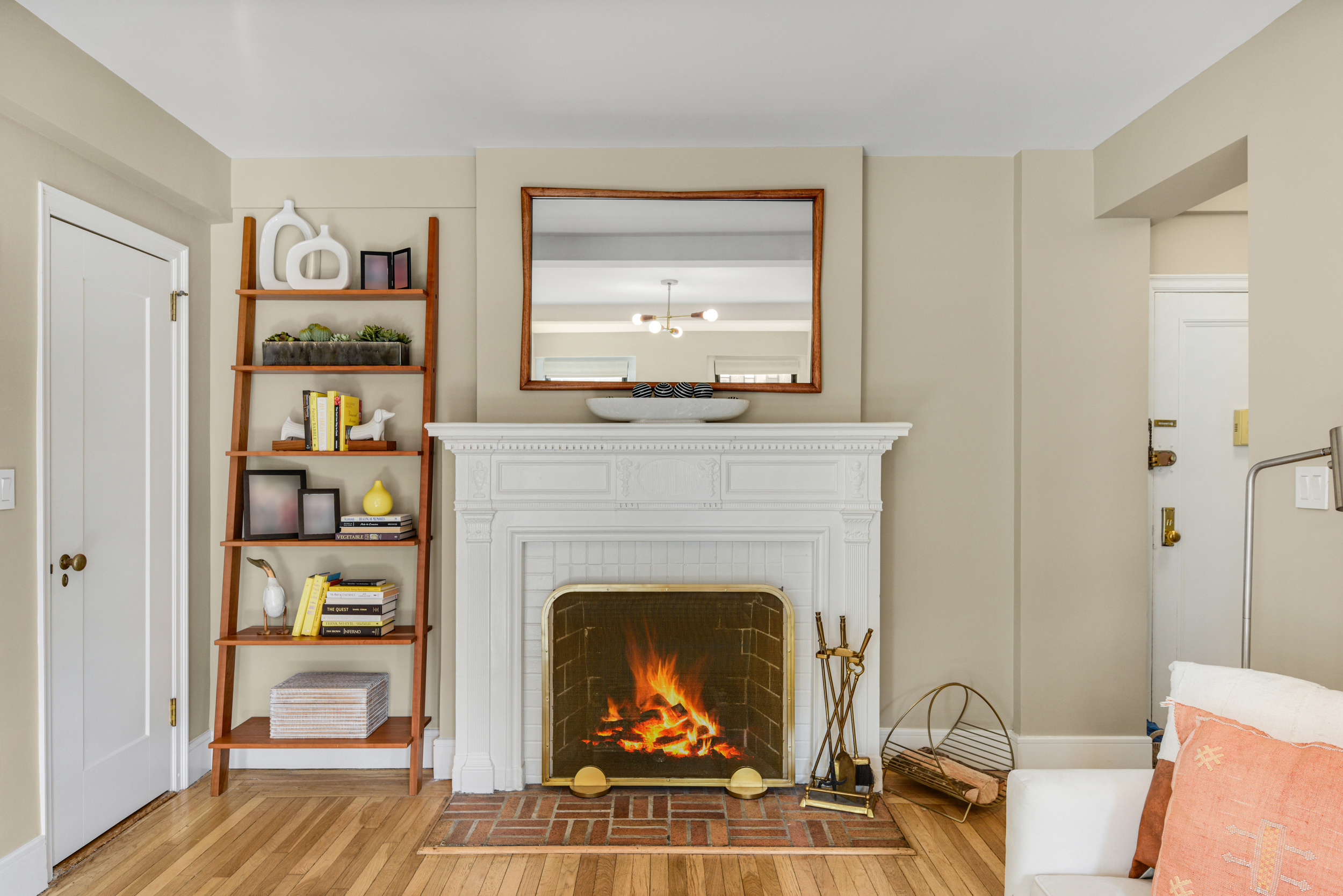205 East 78th Street, Unit 7K Manhattan, NY 10075 - Photo 4 of 14 a living room with furniture a flat screen tv and a fireplace