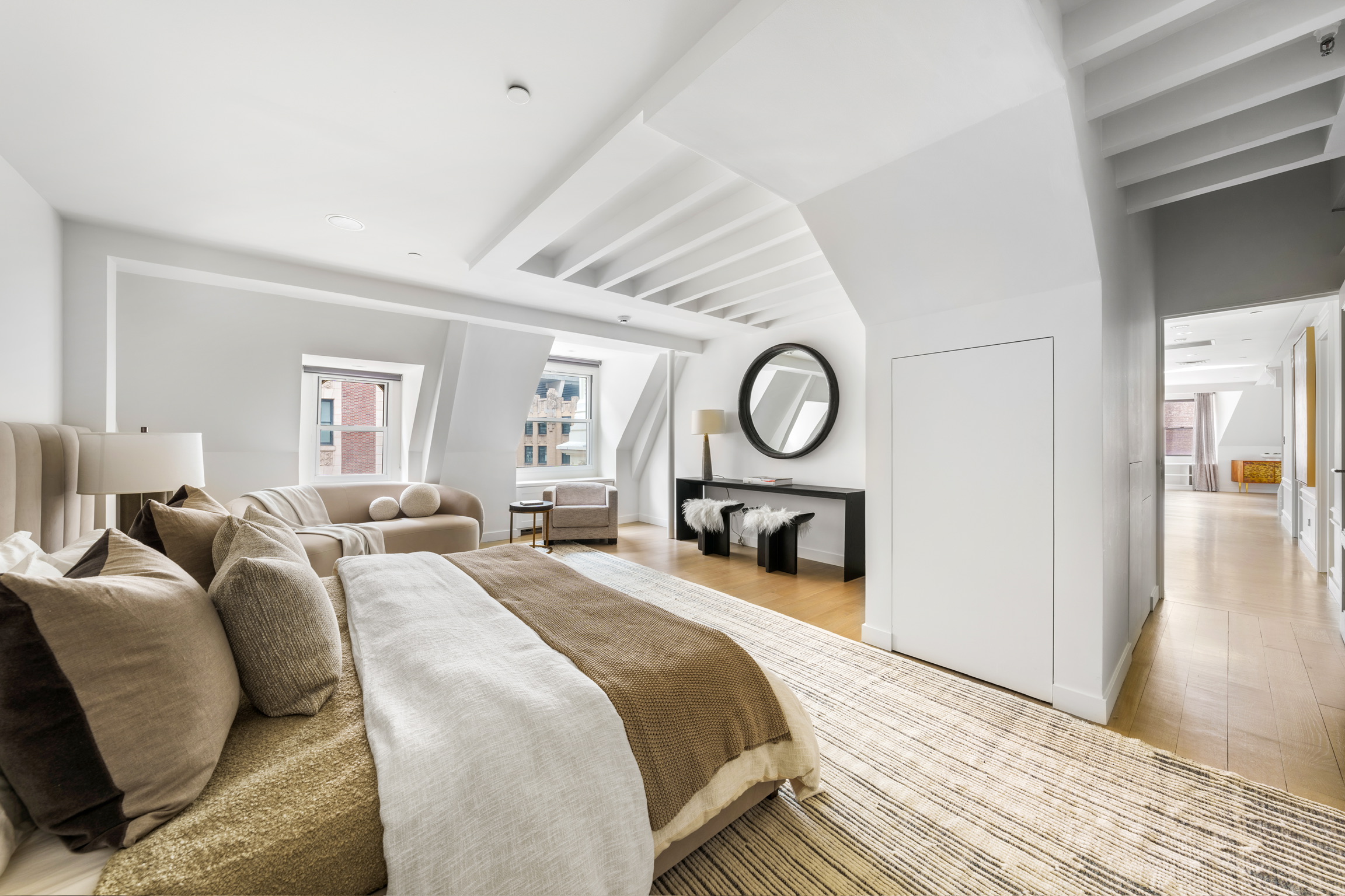 1200 Broadway, Unit PH89 Manhattan, NY 10001 - Photo 20 of 47 a bedroom with bed and a large mirror with wooden floor