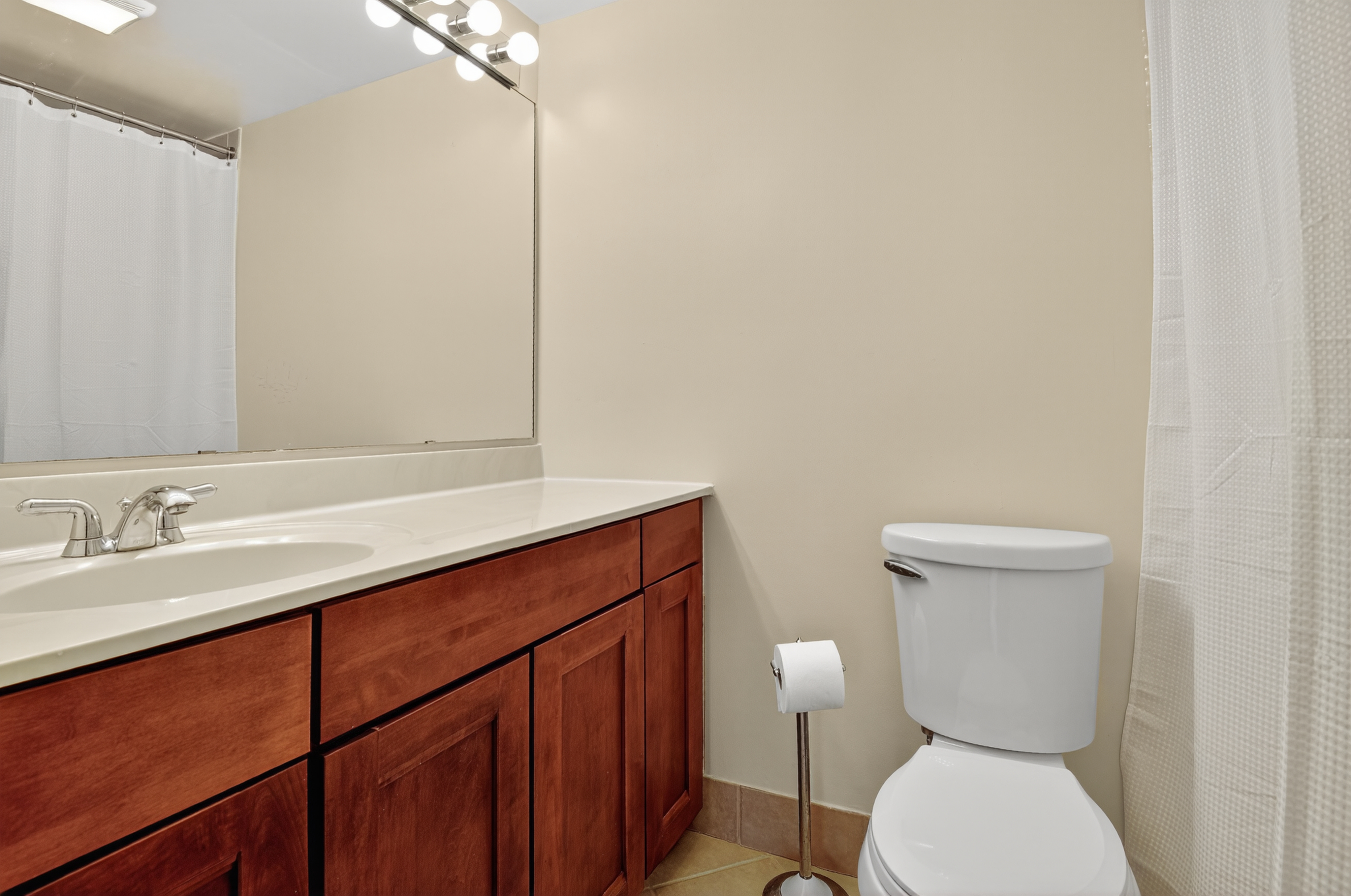 1493 15th Street Northeast, Unit 1493 Washington, DC 20002 - Photo 21 of 26 a bathroom with a toilet a sink and mirror