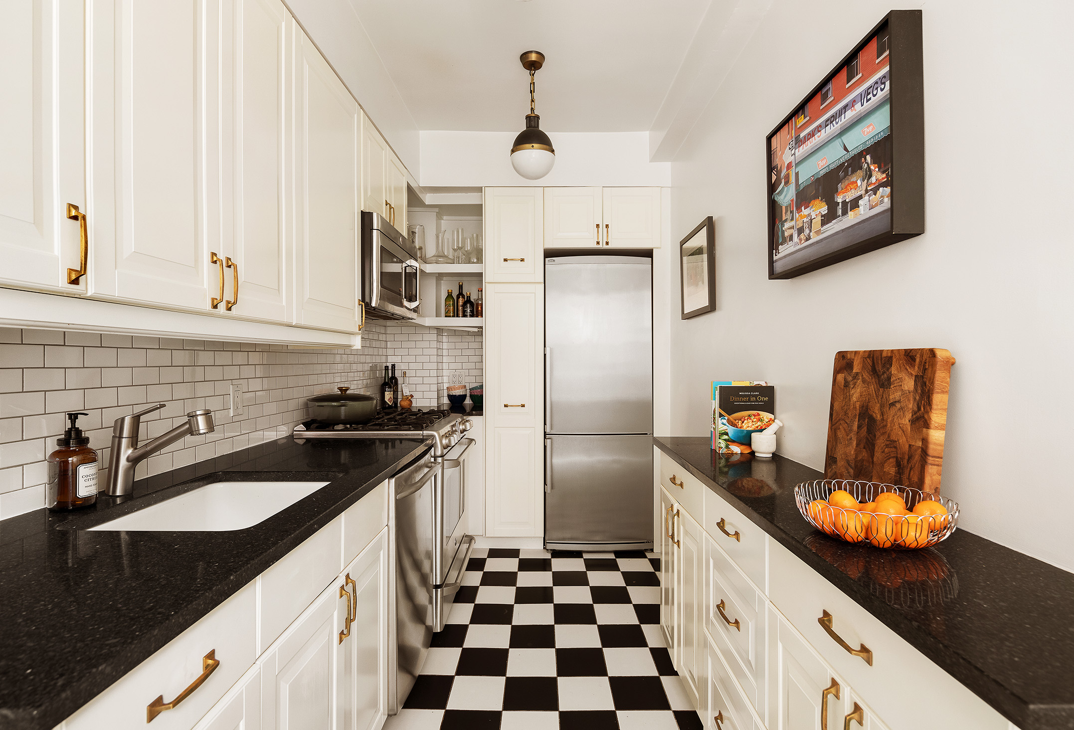41 5th Avenue, Unit 2F Manhattan, NY 10003 - Photo 3 of 12 a kitchen with stainless steel appliances granite countertop a sink stove and refrigerator