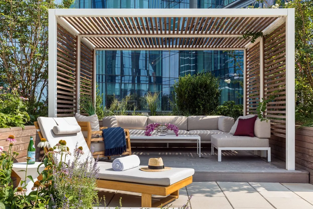 a view of a patio with couches and a table and chairs with wooden floor