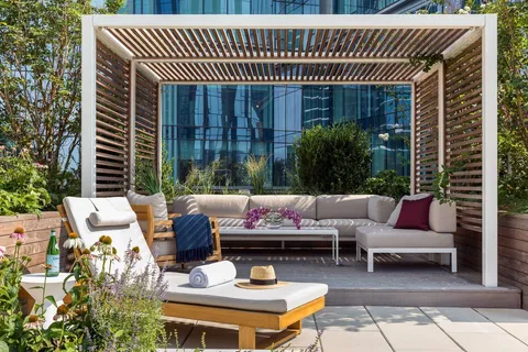 a view of a patio with couches and a table and chairs with wooden floor