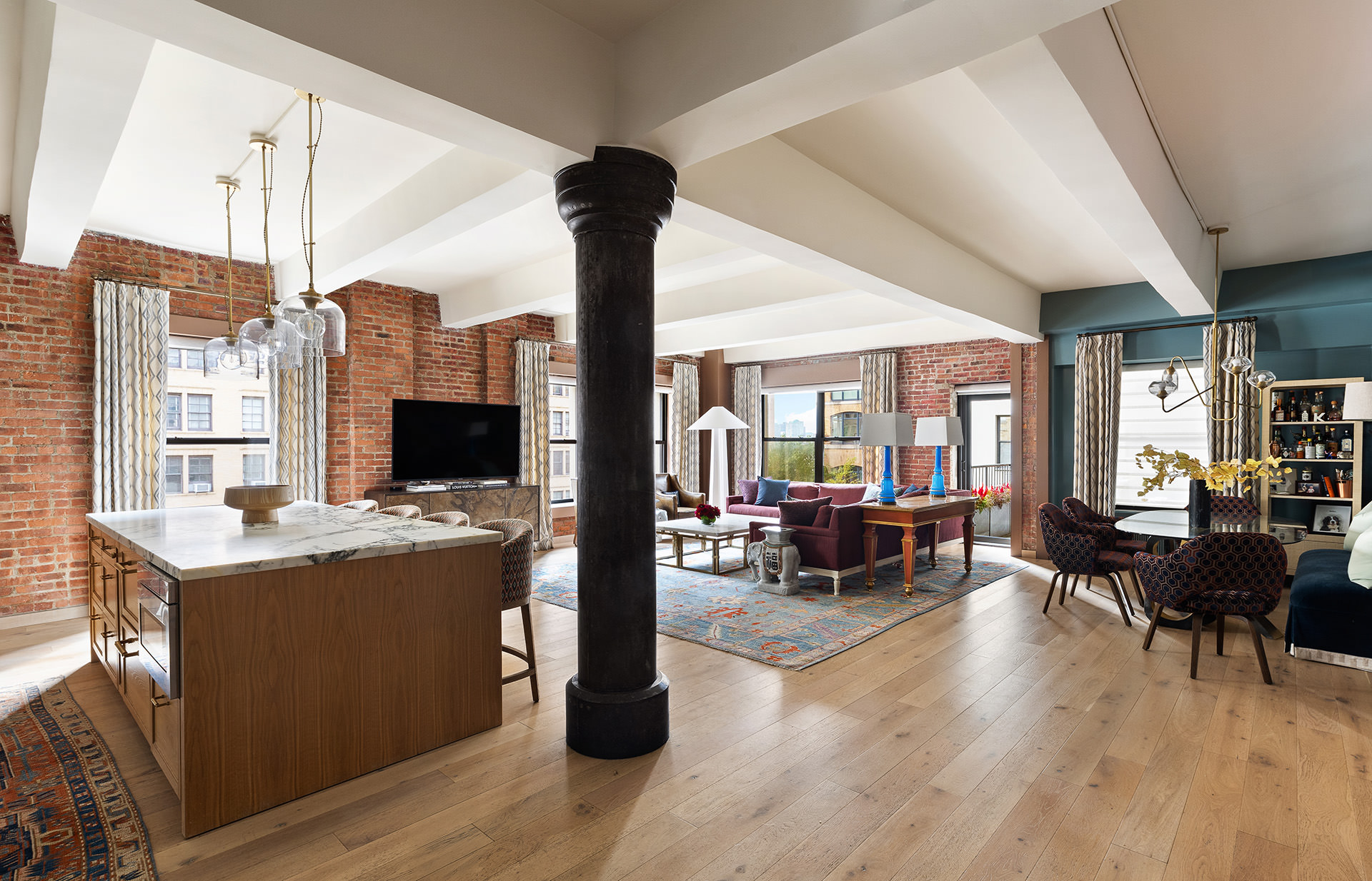 a view of a living room with furniture and a flat screen tv