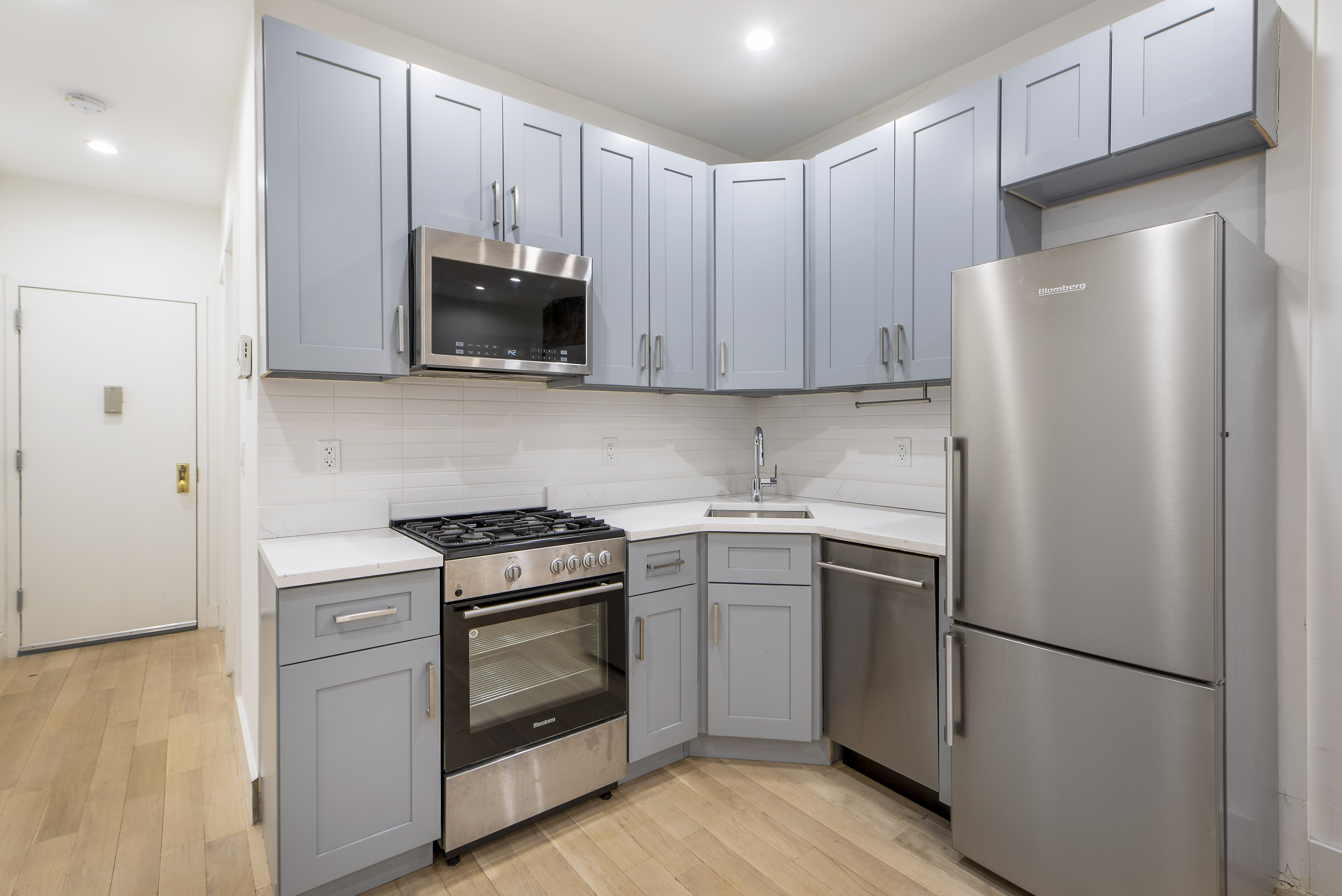 129 2nd Avenue, Unit 8 Manhattan, NY 10003 - Photo 9 of 11 a kitchen with a stove microwave and refrigerator