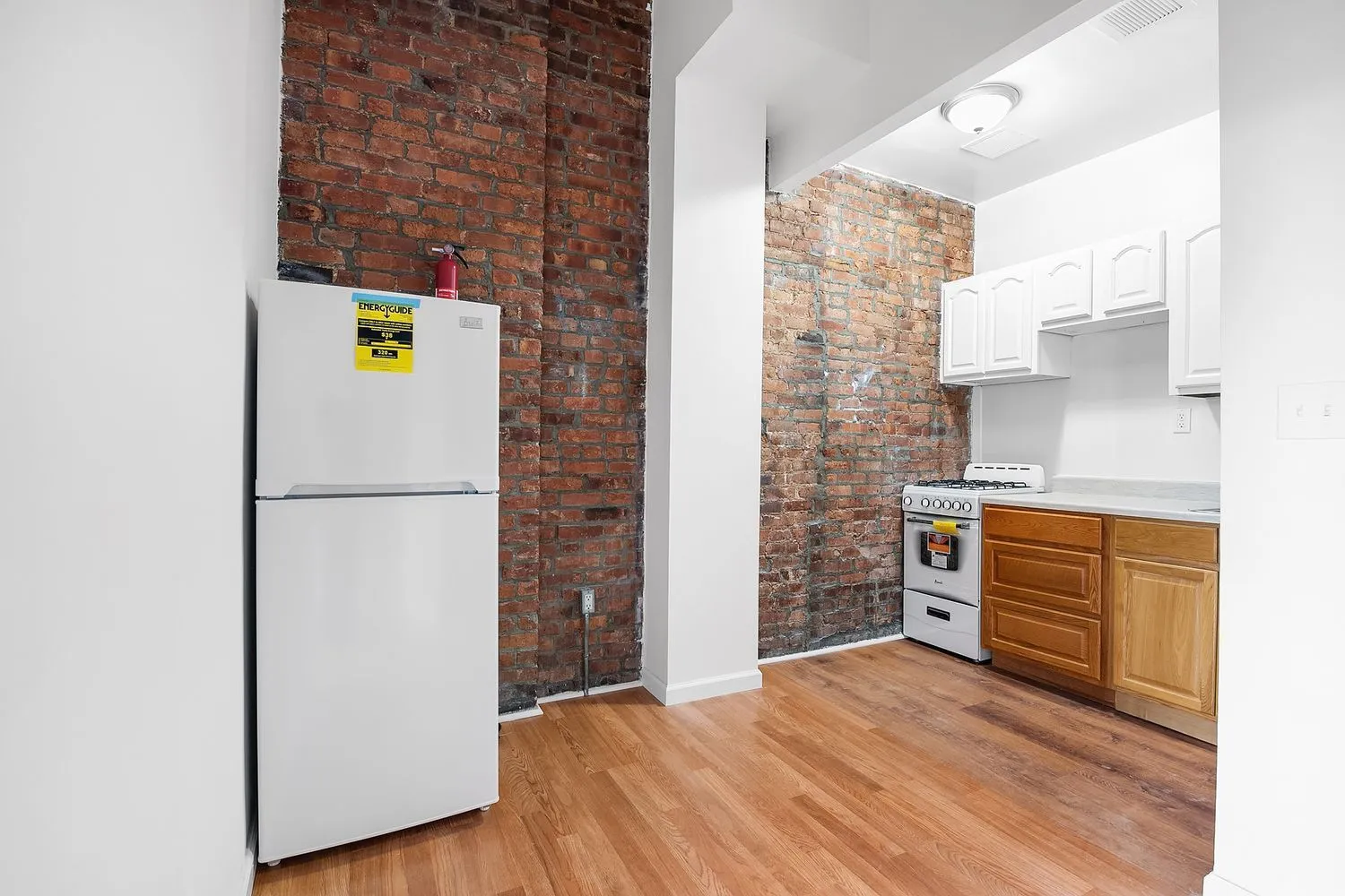 a hallway with cabinets and wooden floor