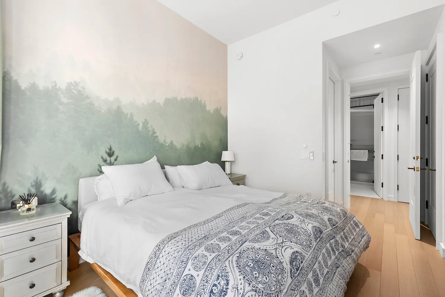 a bedroom with a bed and a mirror