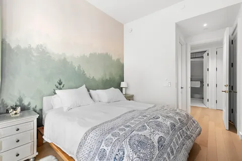 a bedroom with a bed and a mirror