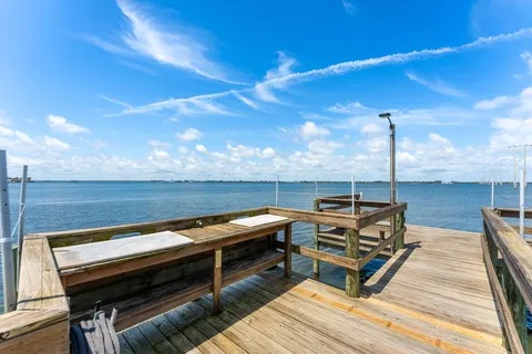a view of a roof deck with wooden floor and outdoor seating