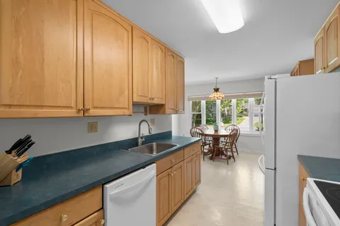 a kitchen with counter top space and dining table