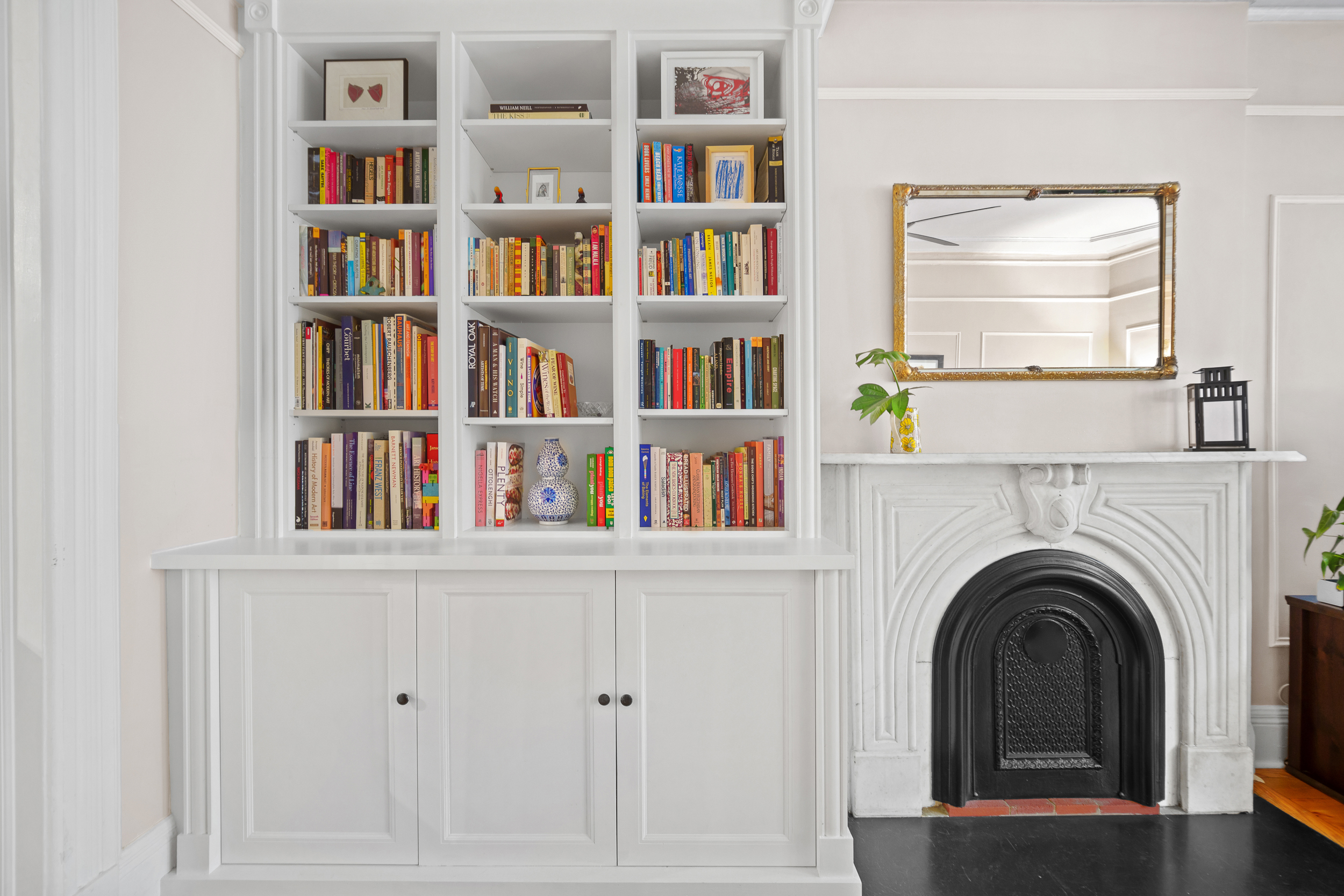 182 Saint Marks Avenue, Unit 2 Brooklyn, NY 11238 - Photo 2 of 14 a view of an empty room with a window and a bookshelf