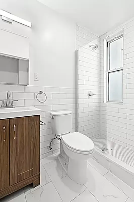 82 Clinton Avenue, Unit 4 Brooklyn, NY 11205 - Photo 7 of 11 a bathroom with a sink a toilet and shower
