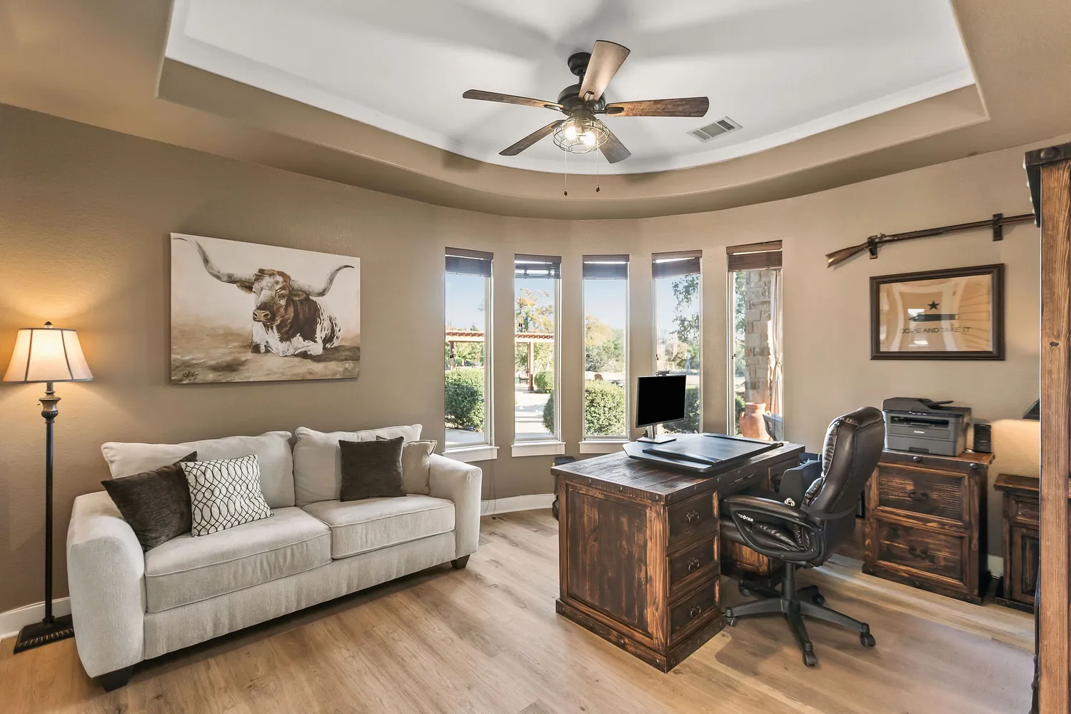 a view of a dining room with furniture a rug and wooden floor