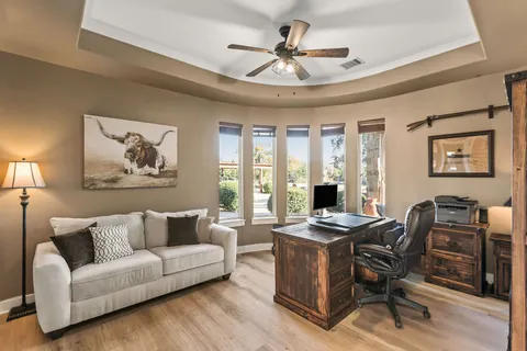 a view of a dining room with furniture a rug and wooden floor