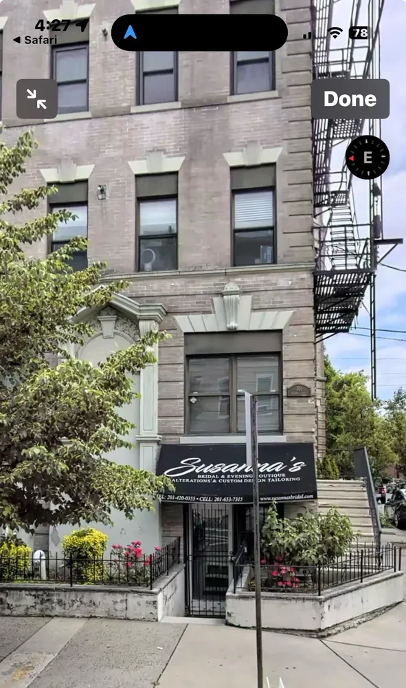 front view of a building with potted plants