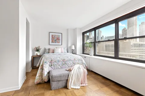 a spacious bedroom with a large bed and a large window