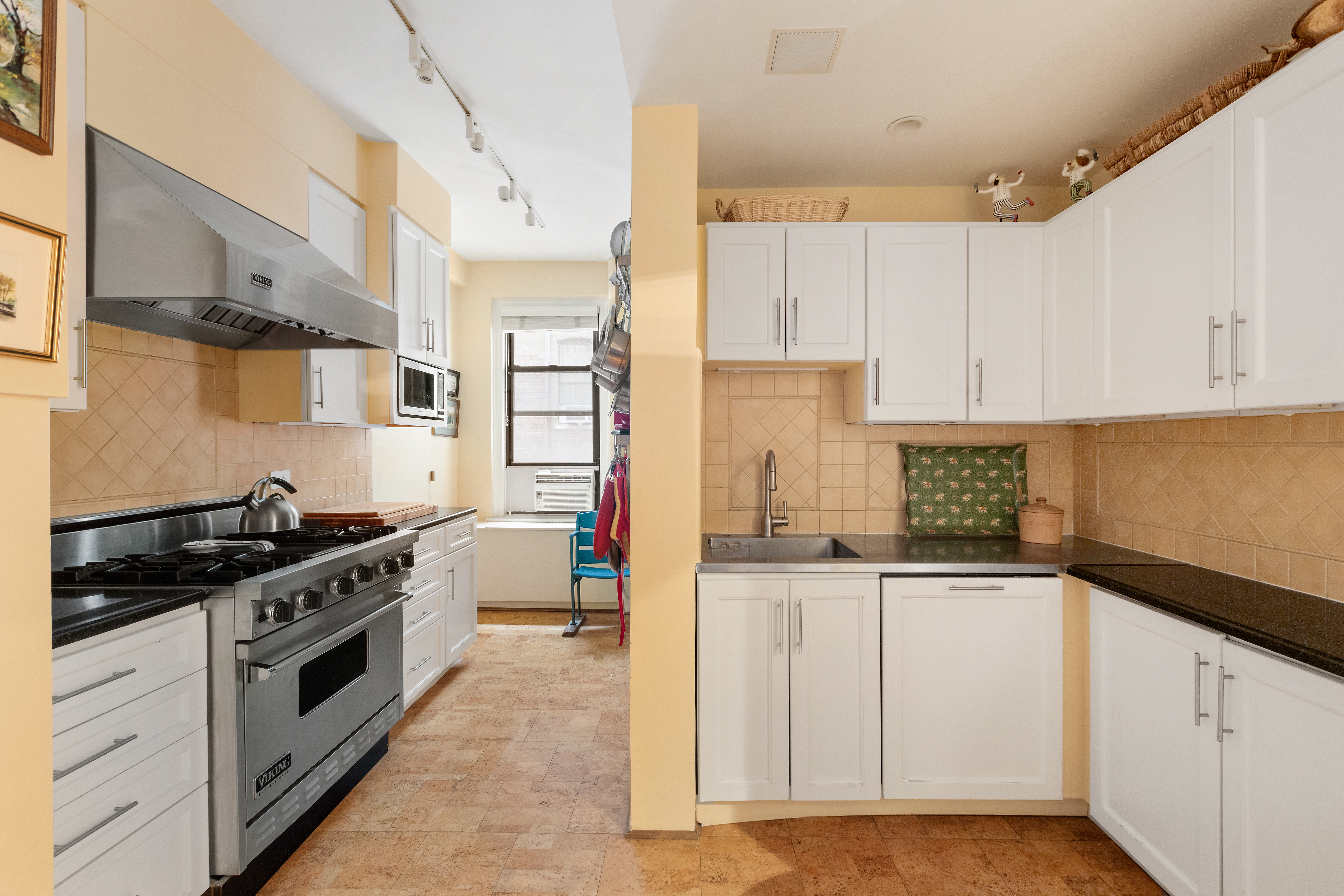 41 West 96th Street, Unit 4B Manhattan, NY 10025 - Photo 6 of 15 a kitchen with granite countertop a sink a stove and cabinets