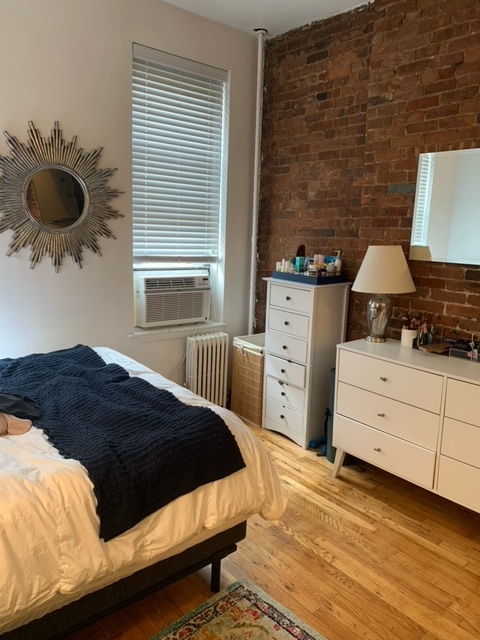 143 Sullivan Street, Unit 12 Manhattan, NY 10012 - Photo 5 of 11 a bedroom with a bed and a window