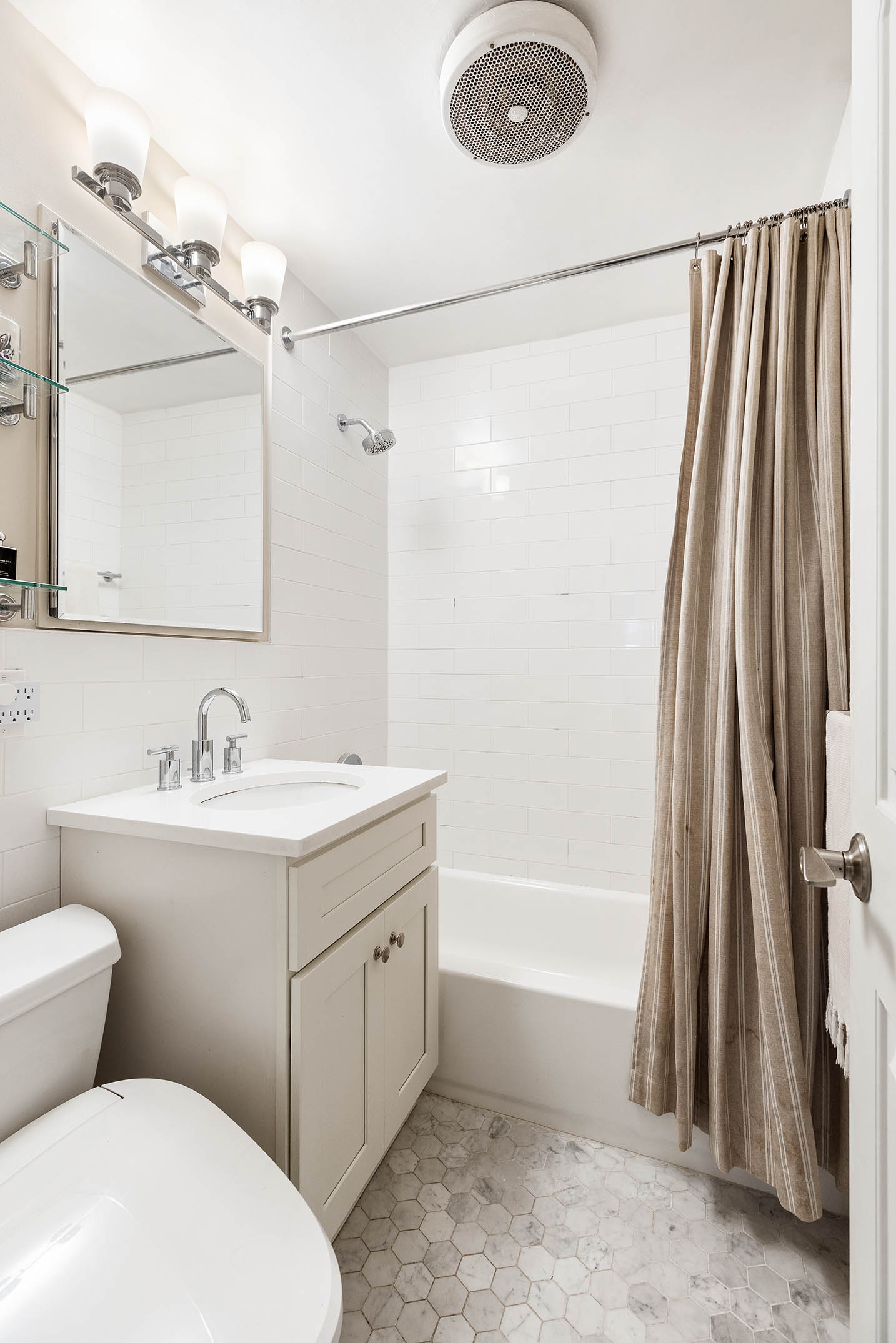 45 Overlook Terrace, Unit 3A Manhattan, NY 10033 - Photo 6 of 9 a bathroom with a sink a toilet a mirror and shower