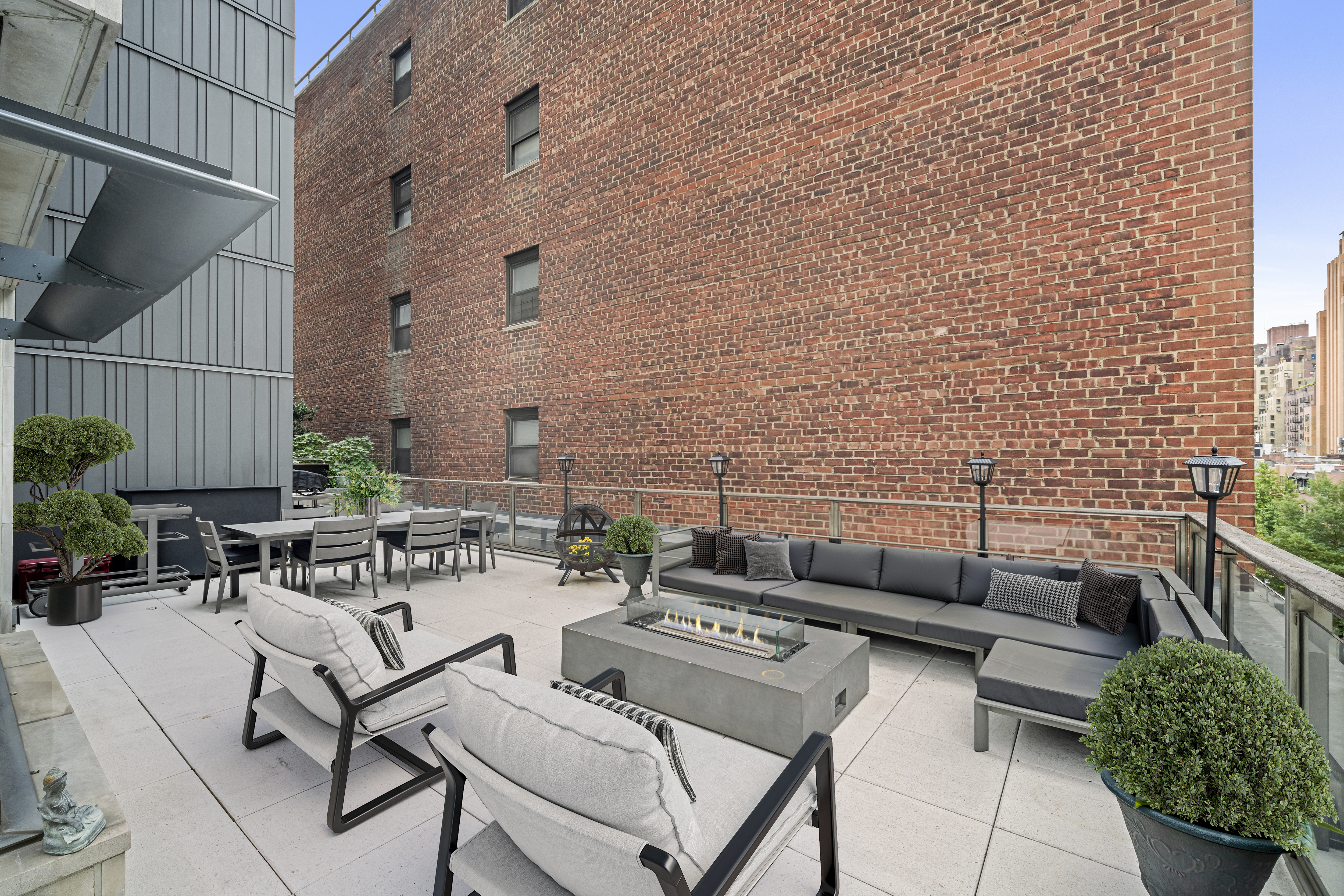 301 East 50th Street, Unit 5A Manhattan, NY 10022 - Photo 4 of 19 a view of a patio with couches and a potted plant on a table