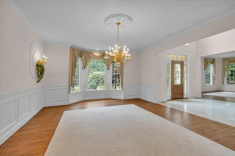 a view of an empty room with a window and a ceiling fan