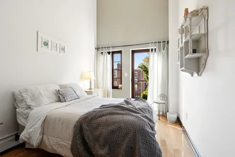 a bedroom with a bed and a window
