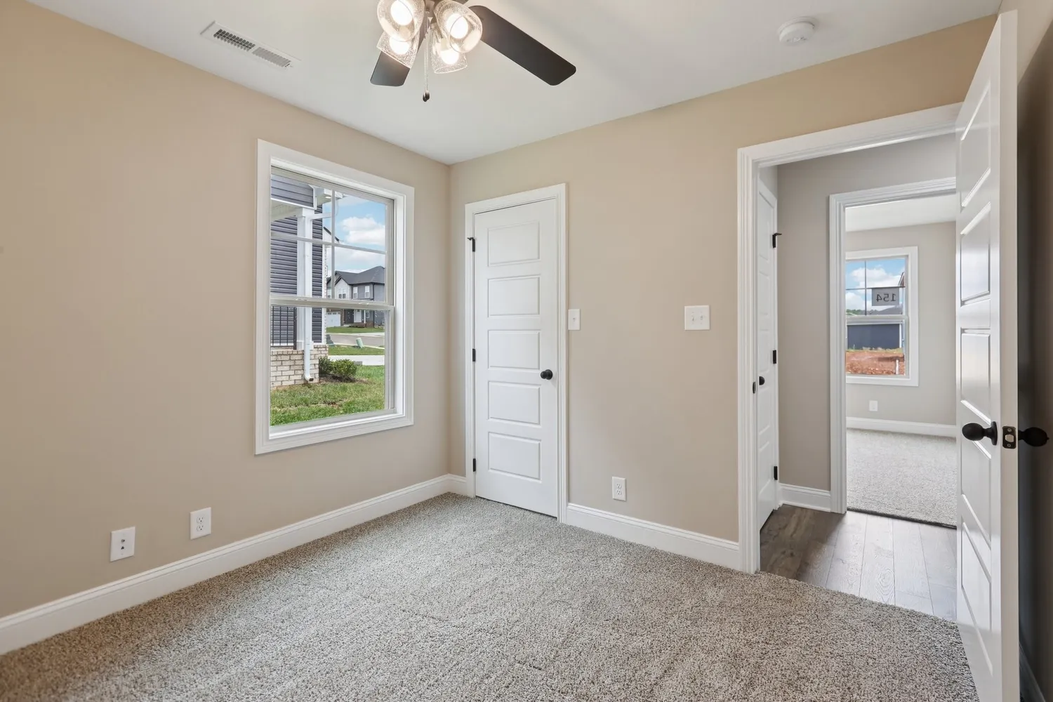 an empty room with windows and closet