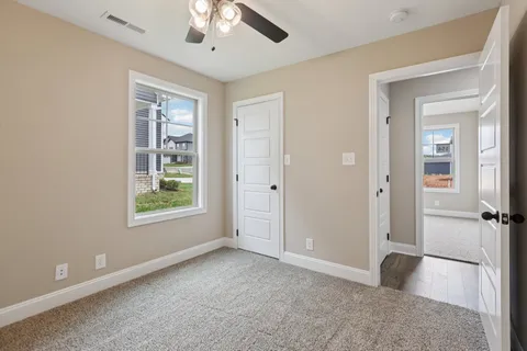 an empty room with windows and closet