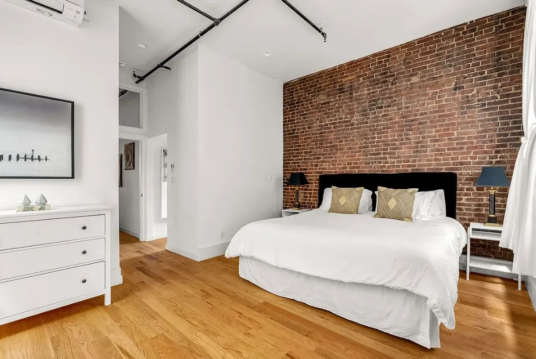 a bedroom with a bed and dresser